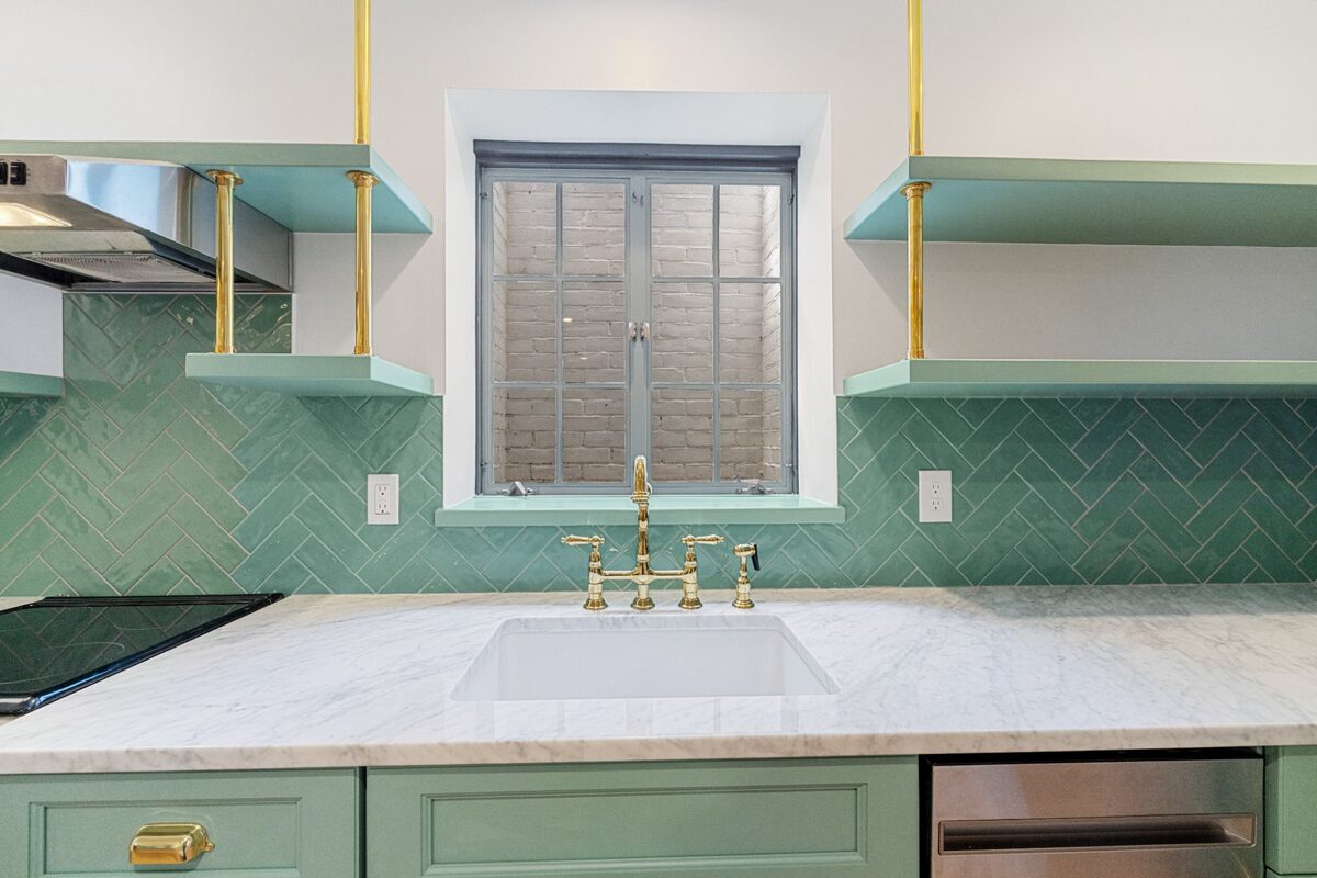 Sage green kitchen with herringbone tile and Carrara marble — Basement Apartment, Butler