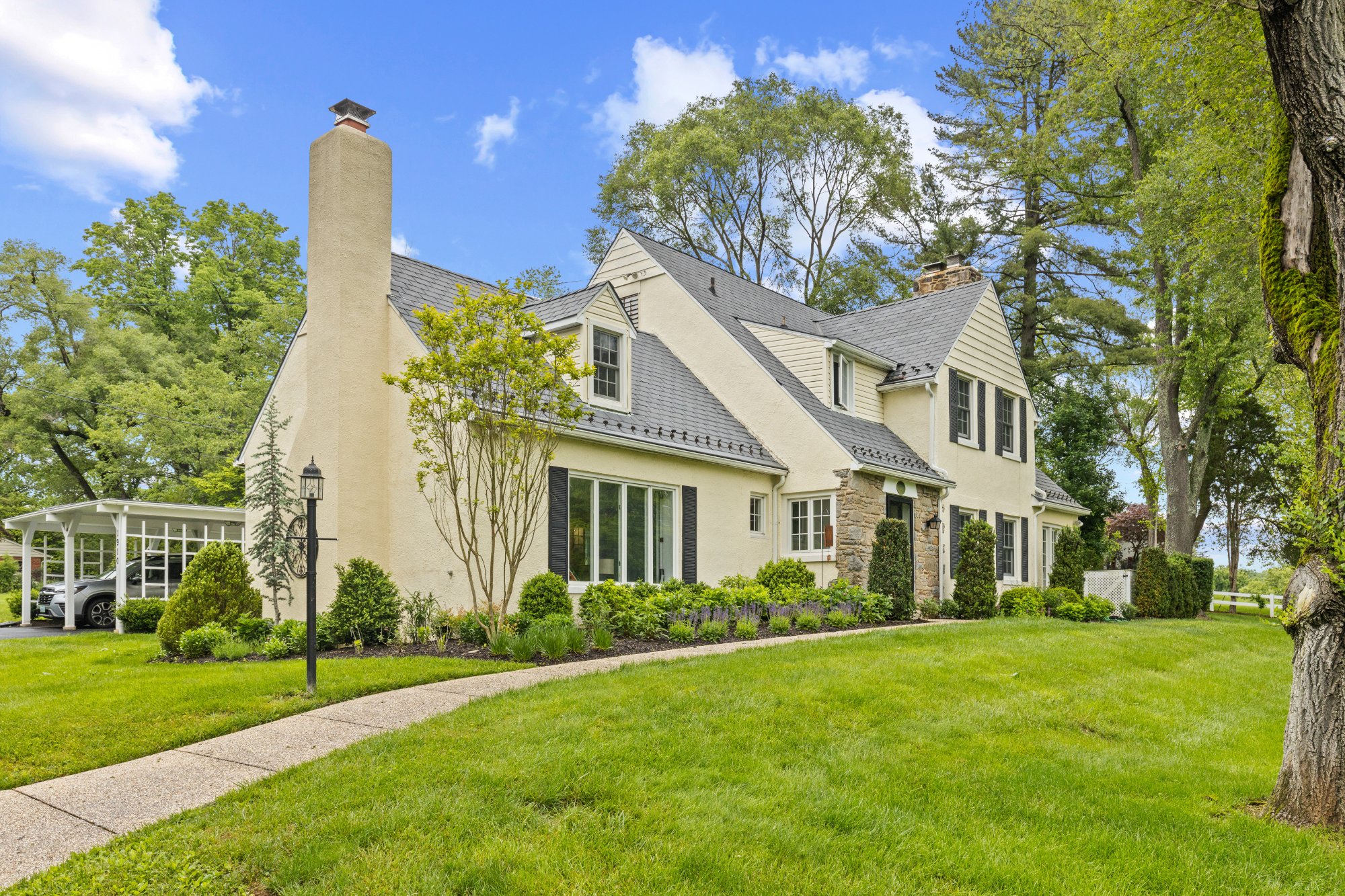 Stucco Tudor cottage exterior after whole-house renovation — Greenspring Valley