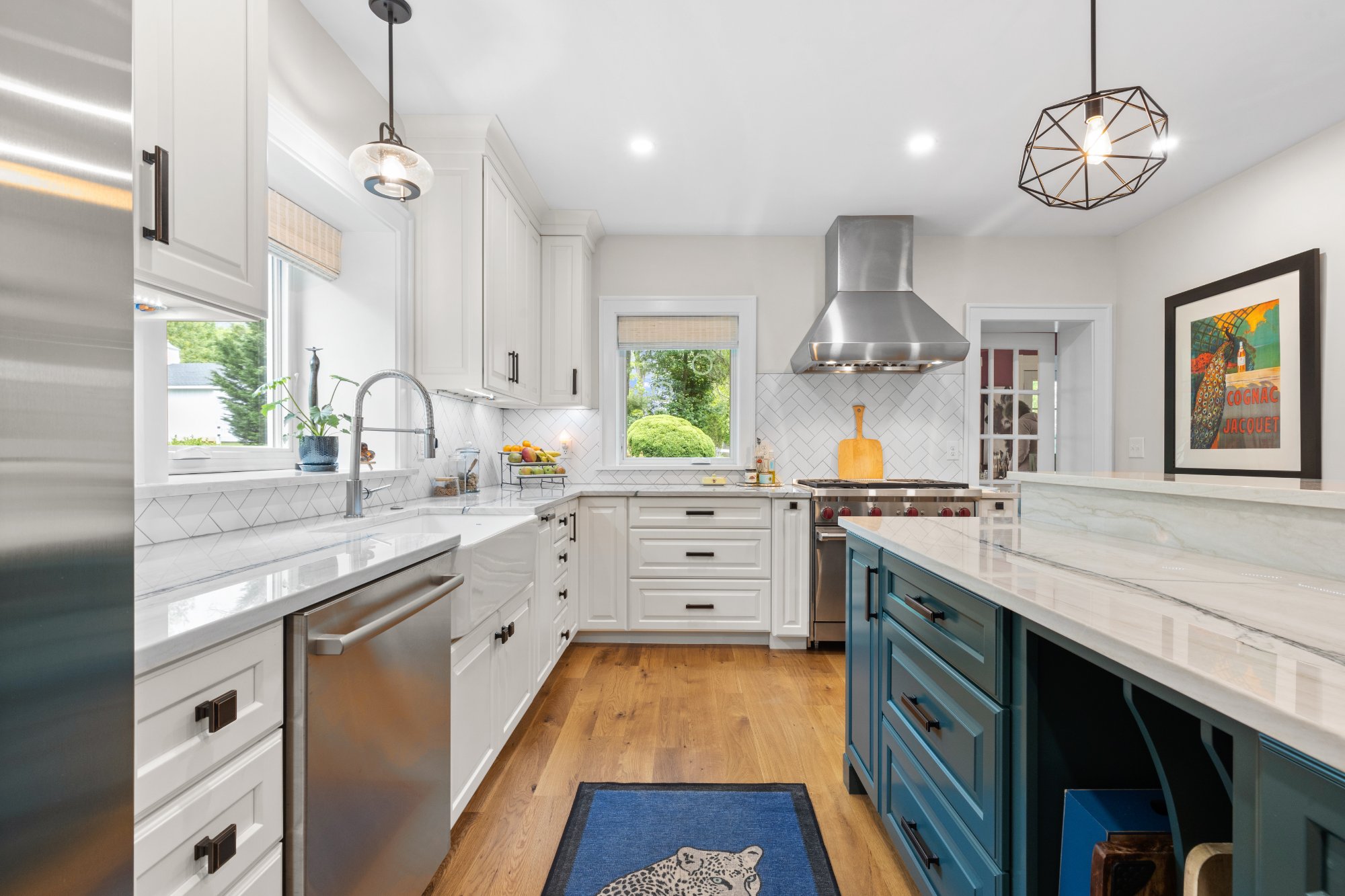 Full kitchen view with farmhouse sink, range, and green island — Greenspring Valley