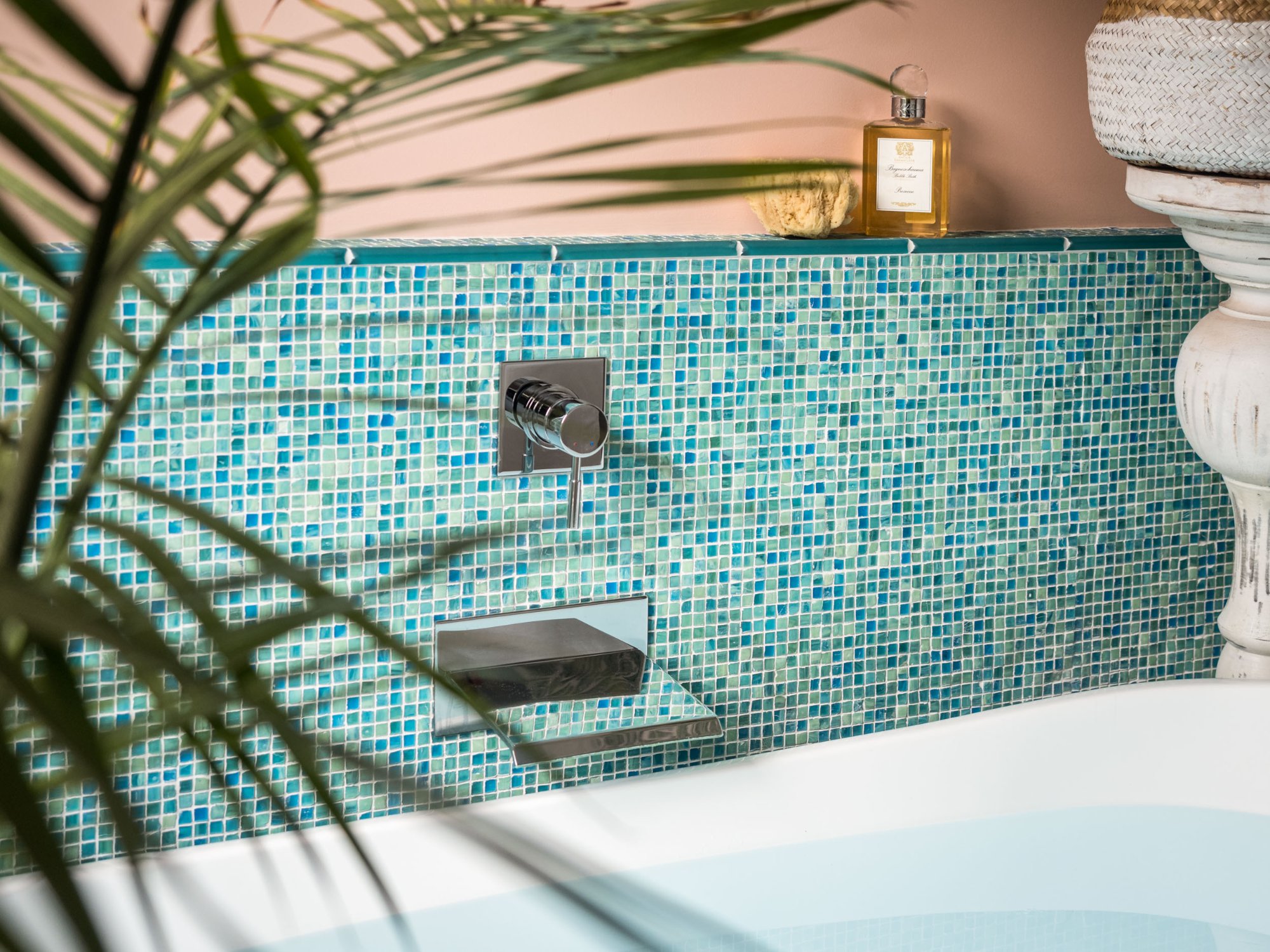 Tub filler detail showing turquoise glass mosaic tile with chrome wall-mount spout and palm fronds — Tropical Master Bath, Hunt Valley