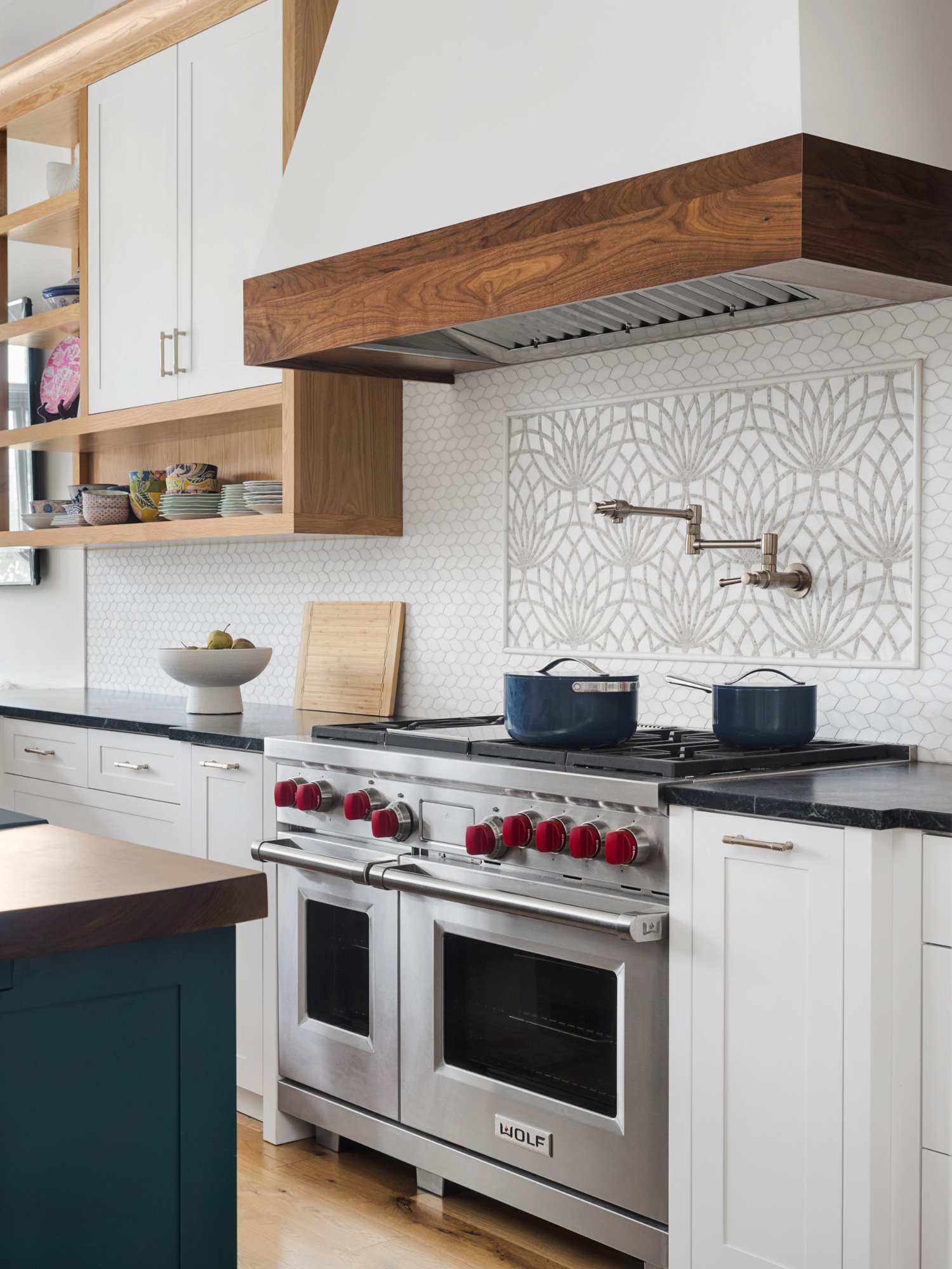 Wolf range with artisan mosaic backsplash medallion, pot filler, and walnut hood surround — Nordic Farmhouse