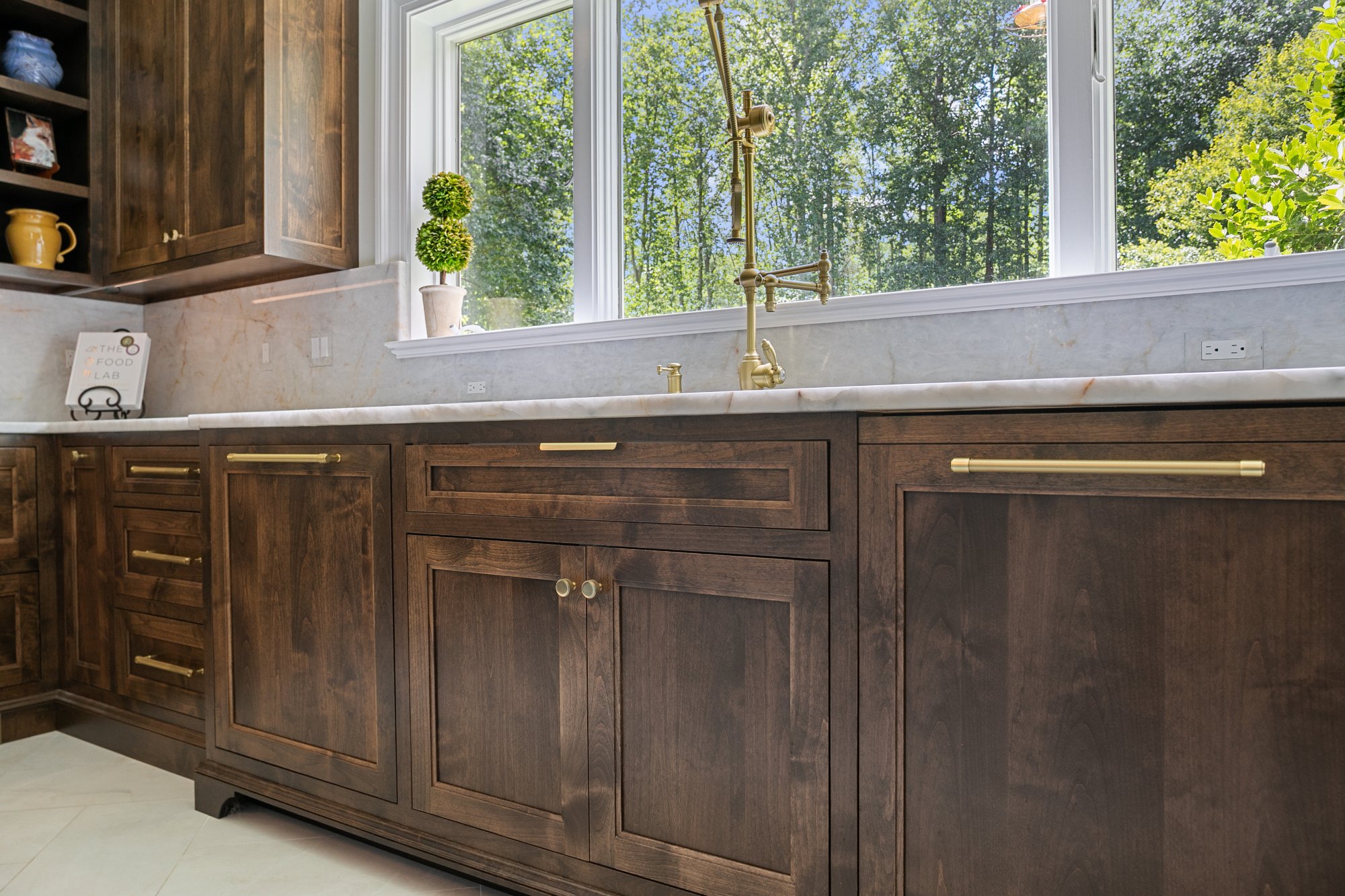 Blue-green cabinetry with brass hardware and cane mesh drawers — Monkton Farms