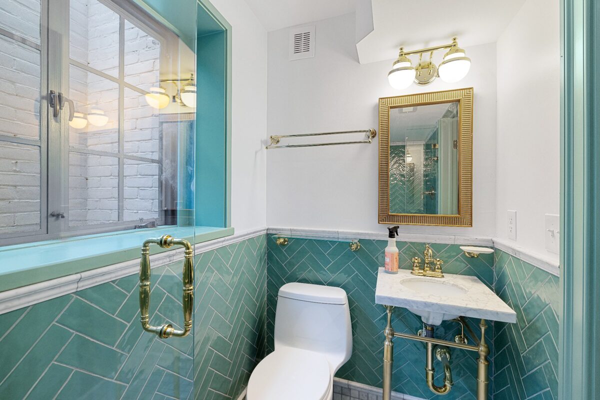 Full bathroom with glass shower, console sink, and herringbone tile — Butler, MD