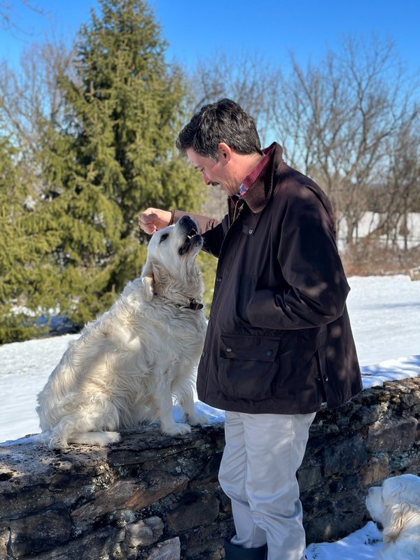 Sam Elder with his dog on a stone wall in Butler, Maryland
