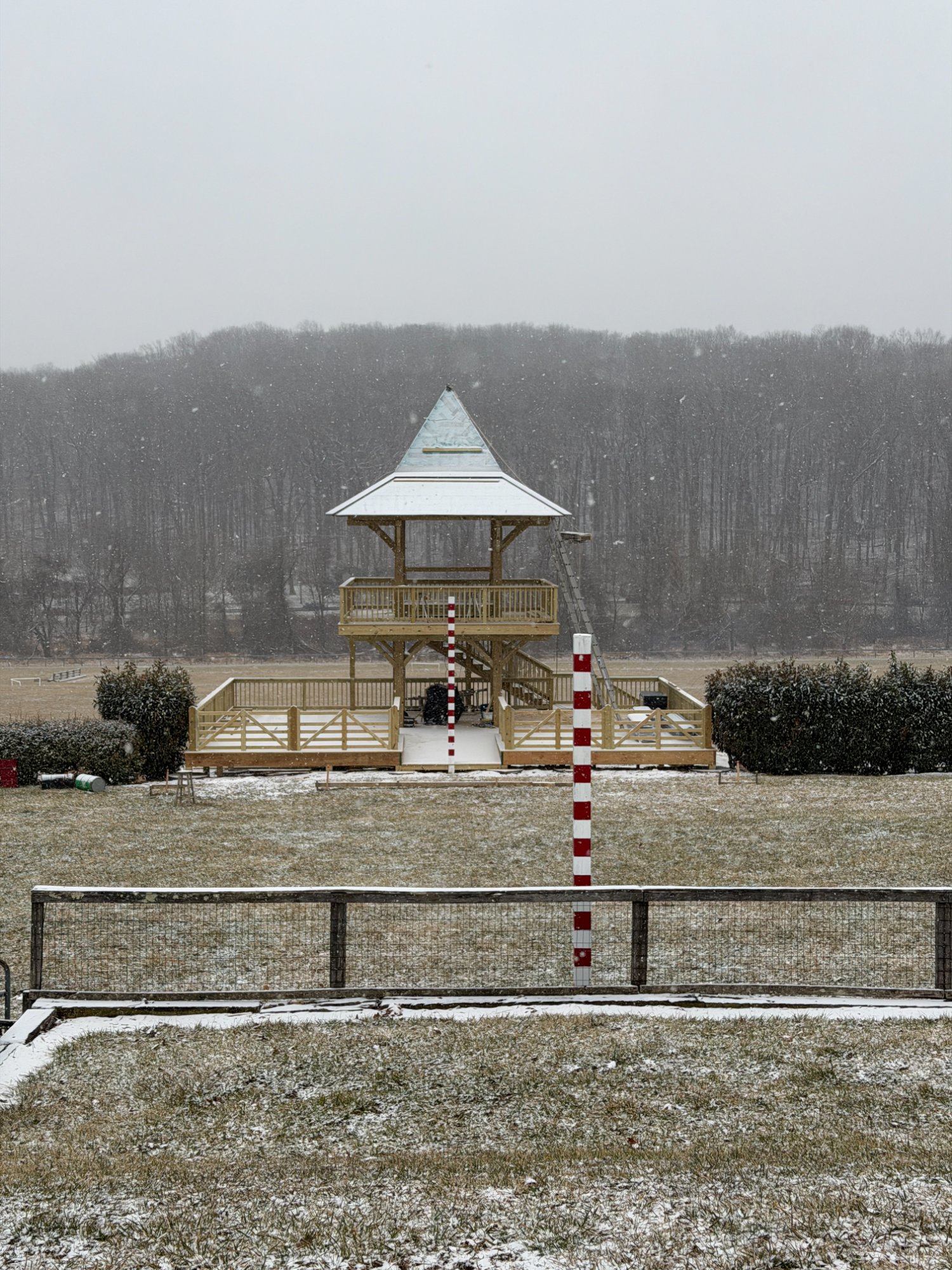 New tower with fresh metal roof dusted in snow, winter atmosphere — Shawan Downs during construction